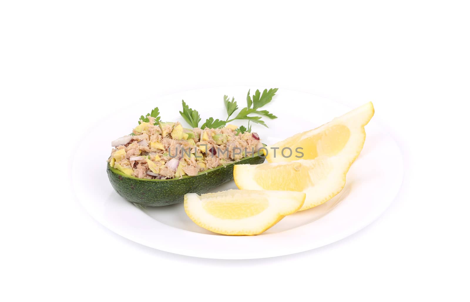 Avocado salad with tuna and lemon. Isolated on a white background.
