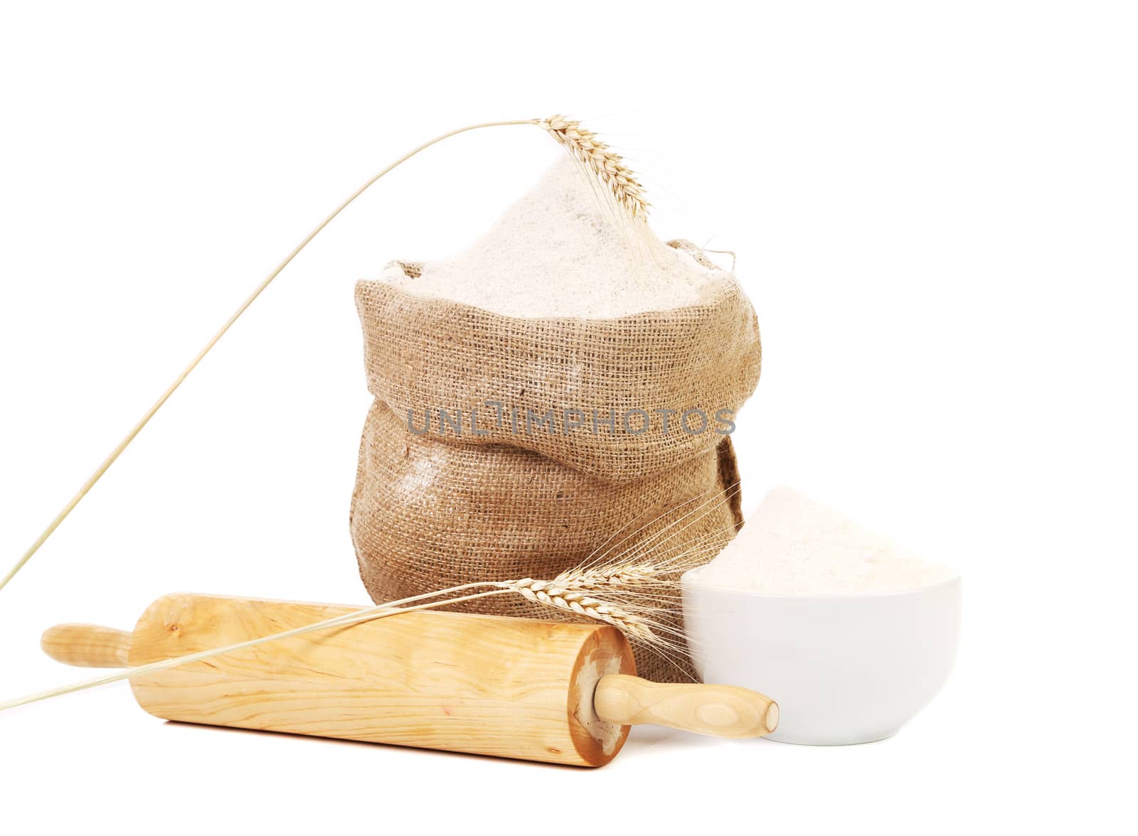 Whole flour in bag with wheat ears. Isolated on a white background.
