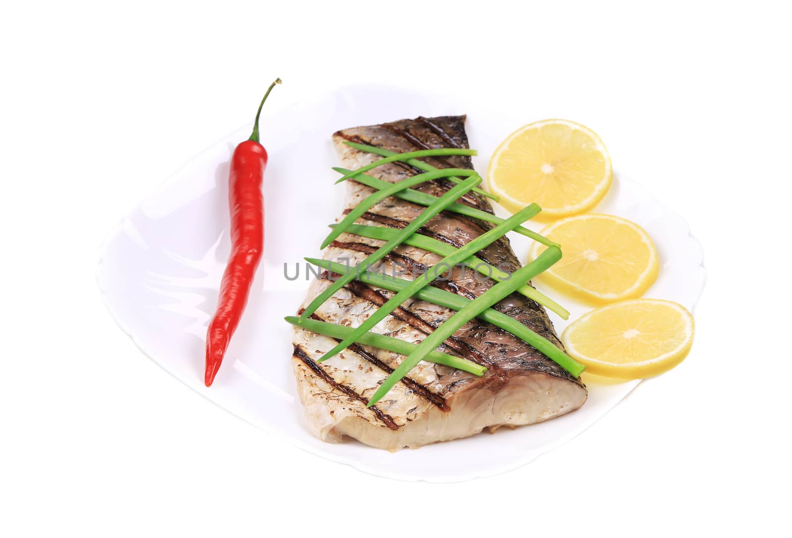 Grilled fish with vegetables. Isolated on a white background.