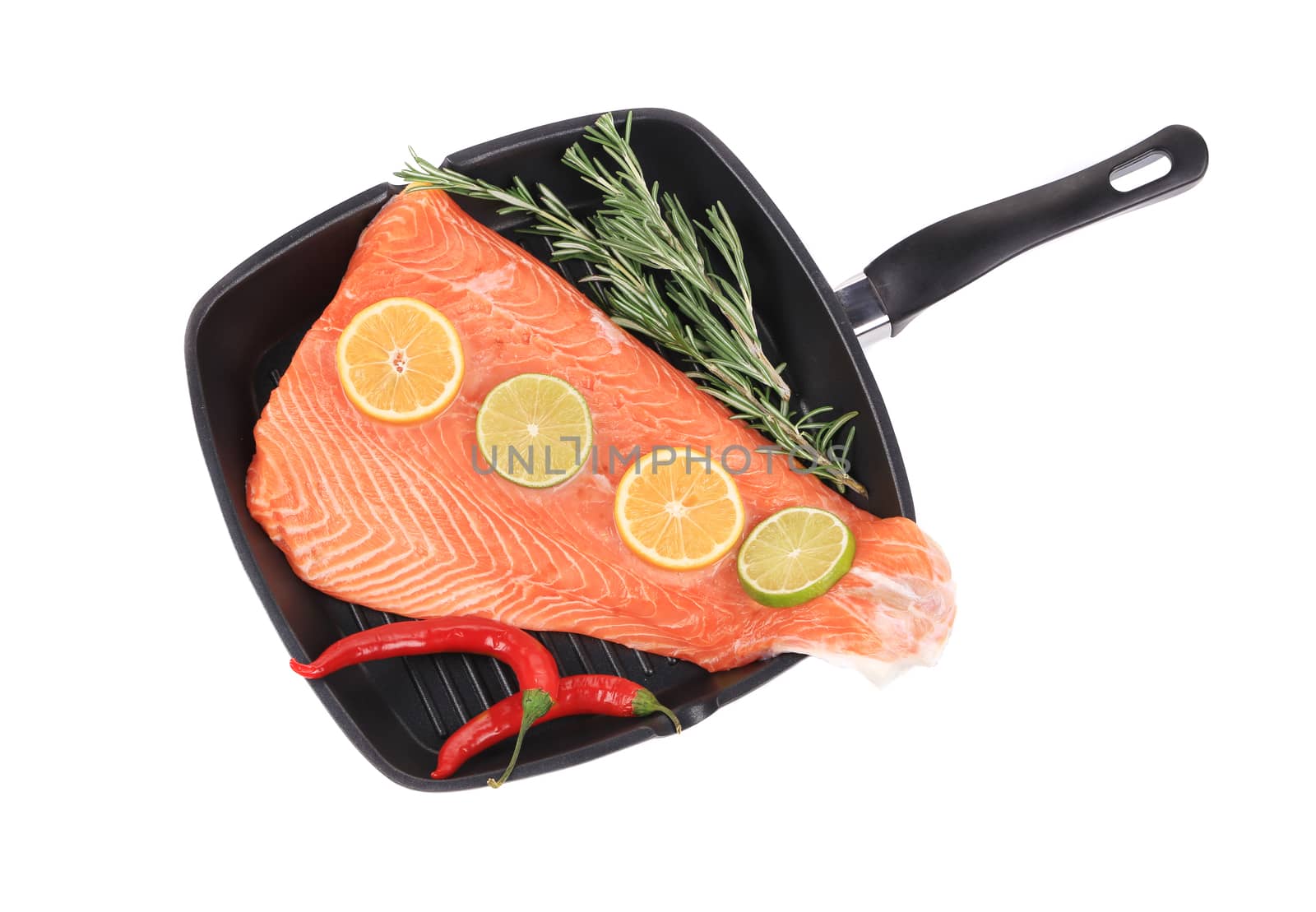 Raw salmon on frying pan with rosemary. Isolated on a white background.