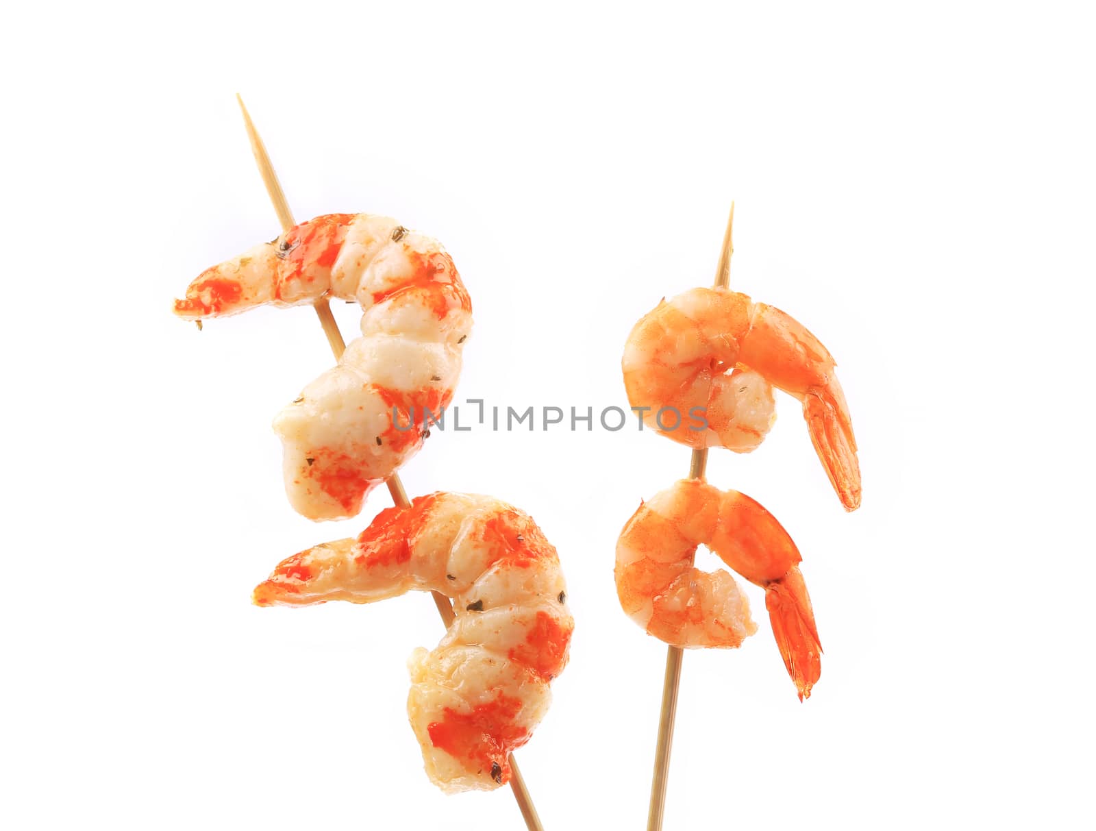 Boiled shrimps on skewers. Isolated on a white background.