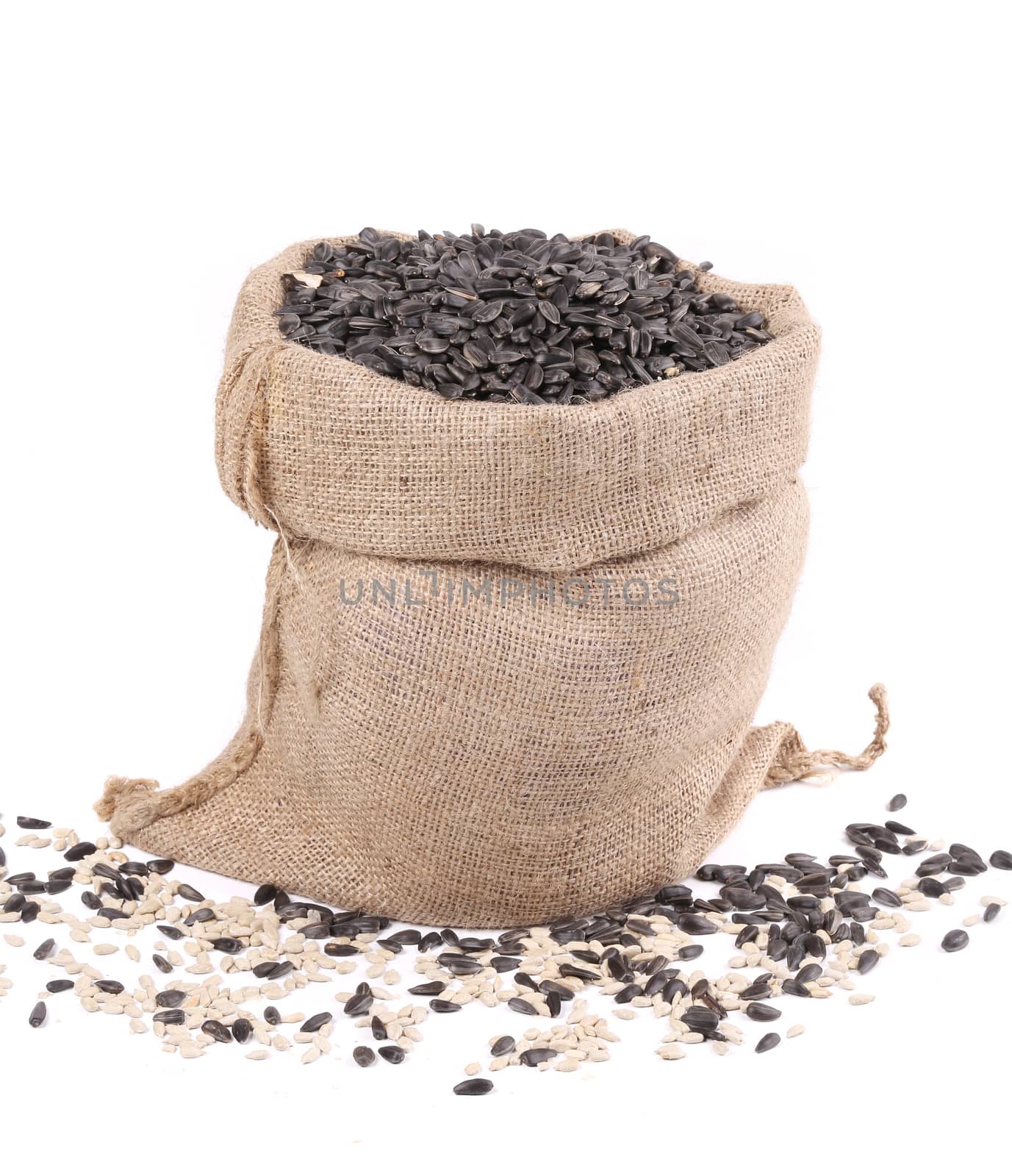 Burlap sack with sunflower seeds. Isolated on a white background.