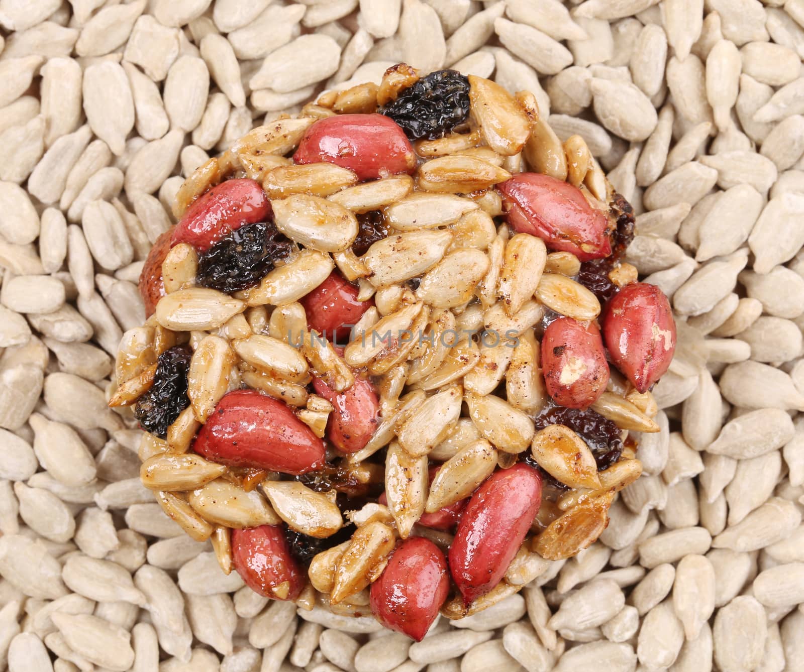 Sunflower seeds and raisins in caramel. Isolated on a white background.