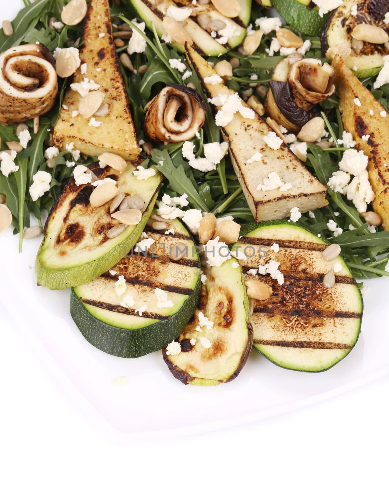 Salad with grilled vegetables and tofu. Whole background.