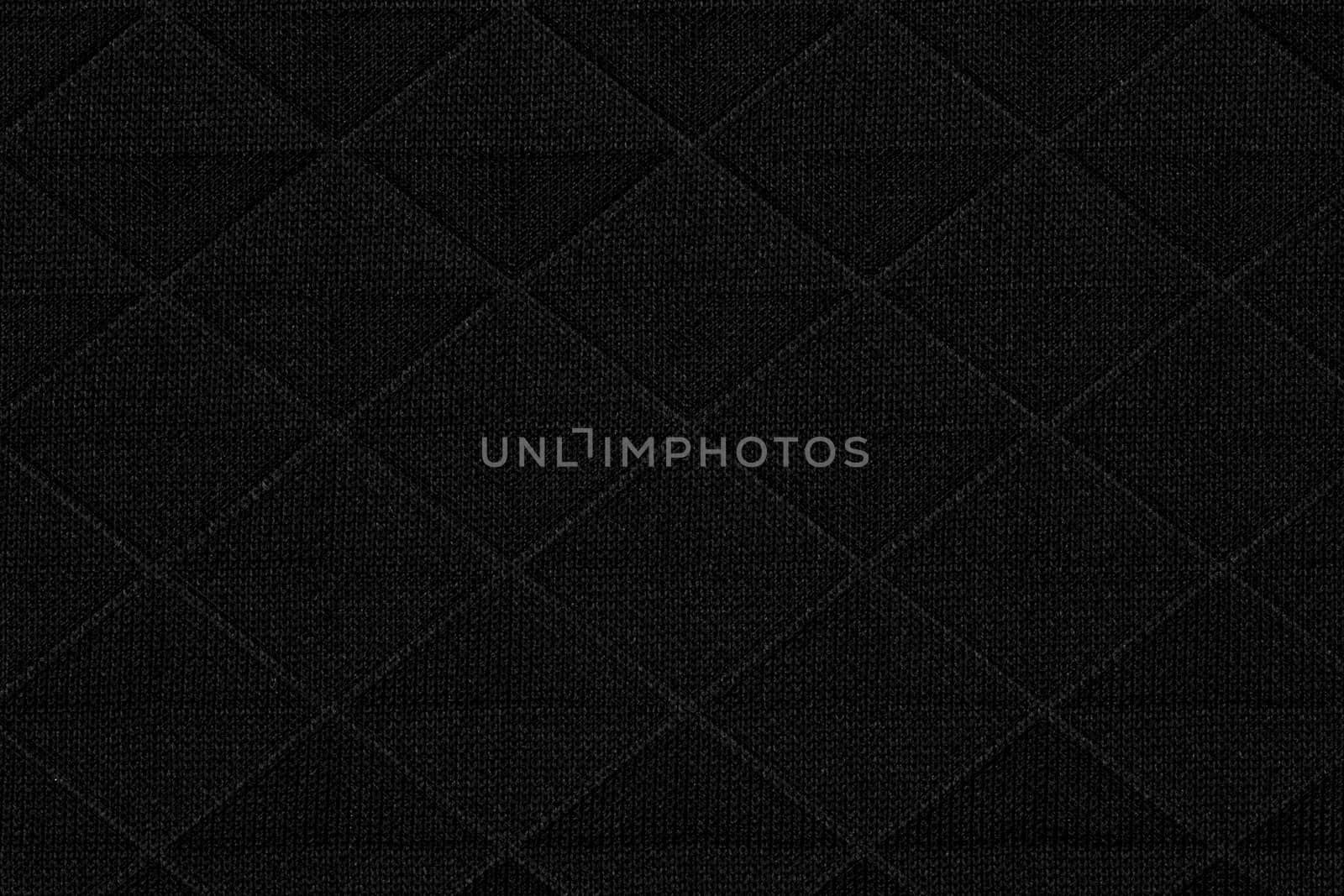 Black fabric with geometric patterns, a background or texture