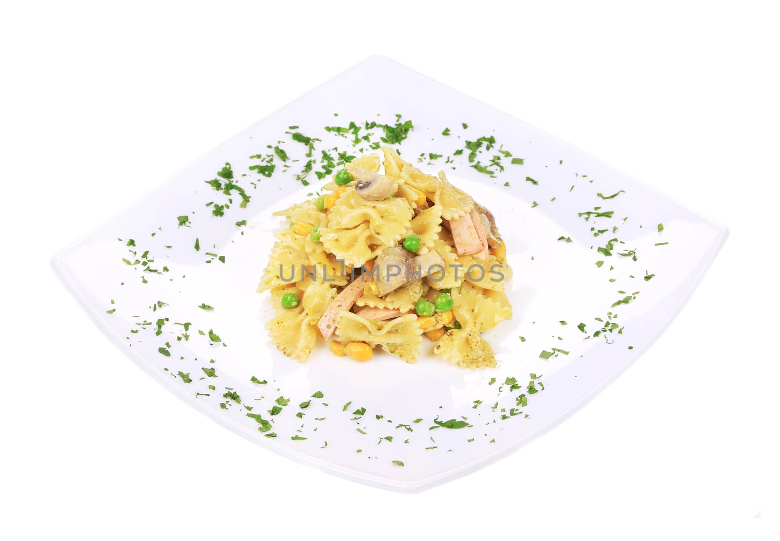 Pasta with ham and mushrooms in sauce pesto. Isolated on a white background.