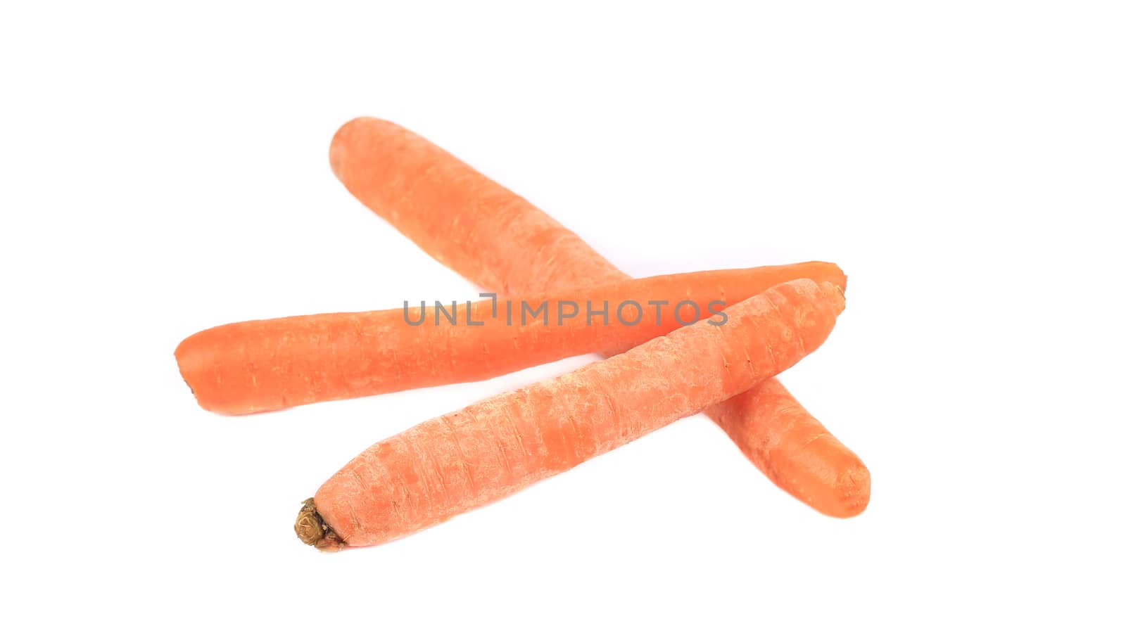 Three fresh carrots cross. Isolated on a white background.