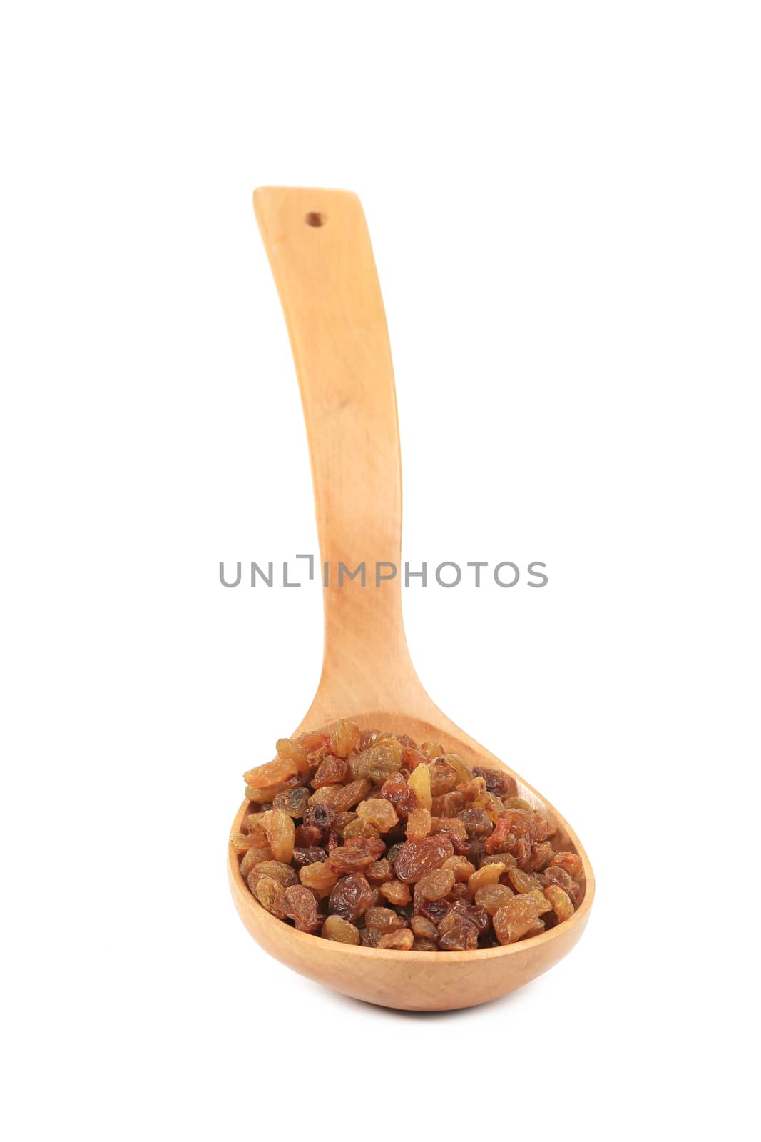 Wooden spoon with raisins. Isolated on a white background.