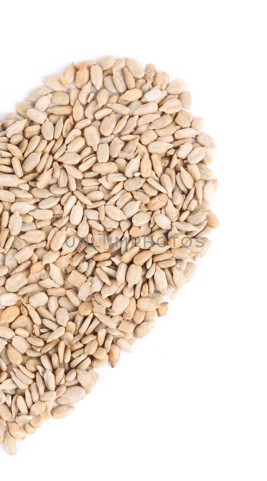 Sunflower seeds in the shape of heart. Isolated on a white background.