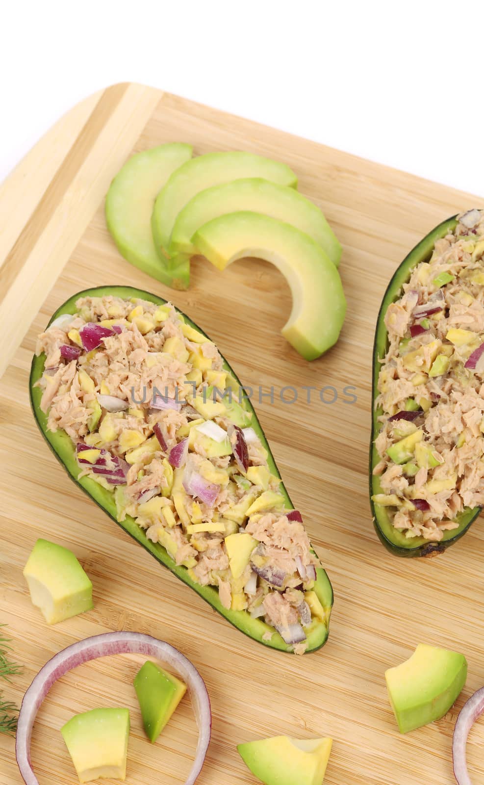 Avocado salad with tuna on cutting board. by indigolotos