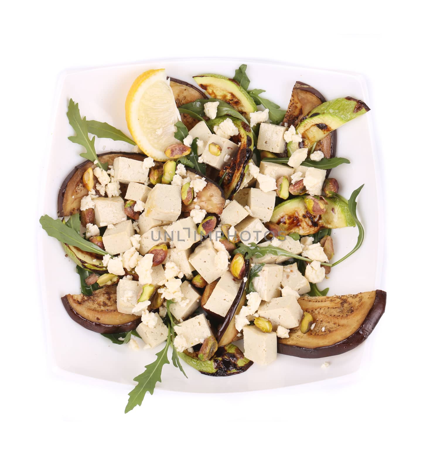 Salad with grilled vegetables and tofu. Isolated on a white background.