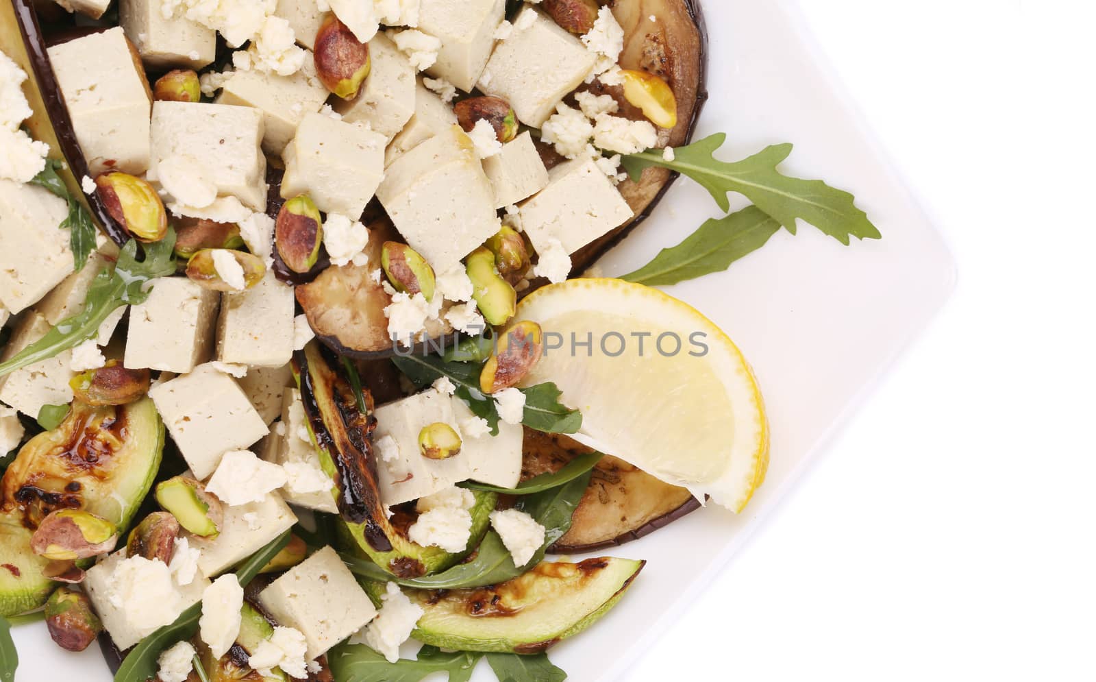 Salad with grilled vegetables and tofu. Isolated on a white background.