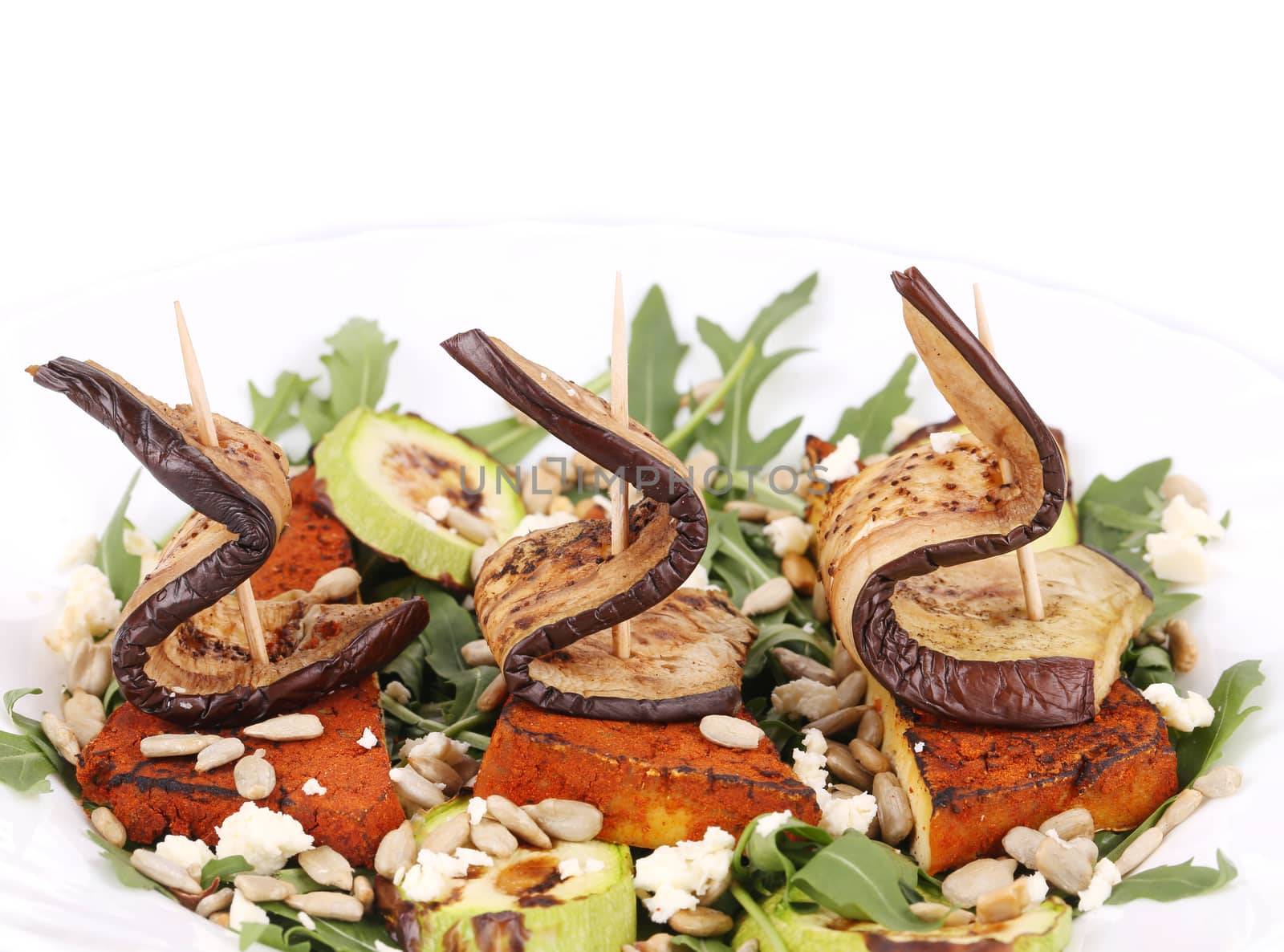 Salad with grilled vegetables and tofu. Isolated on a white background.