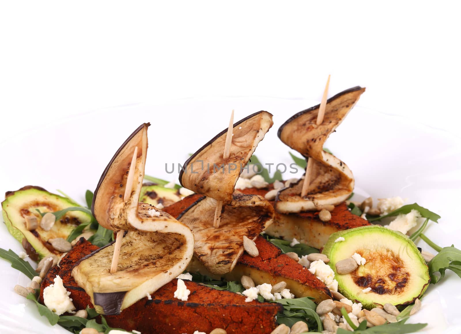 Salad with grilled vegetables and tofu. Isolated on a white background.
