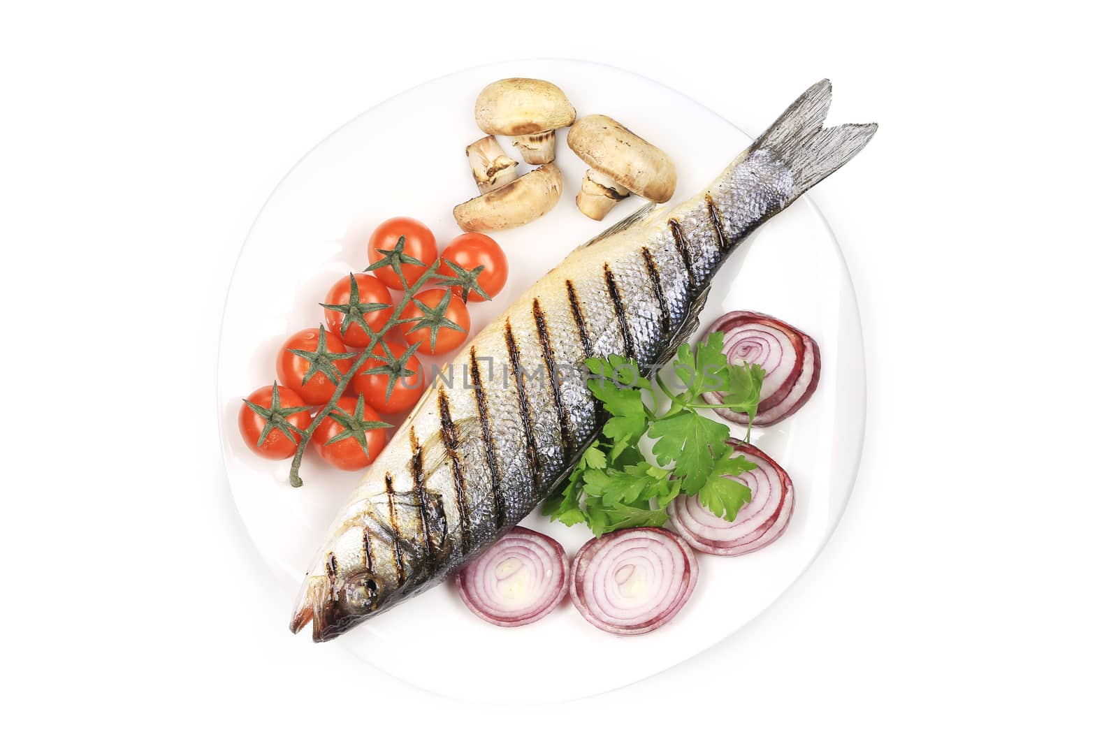 Grilled seabass on plate with mushrooms. Isolated on a white background.