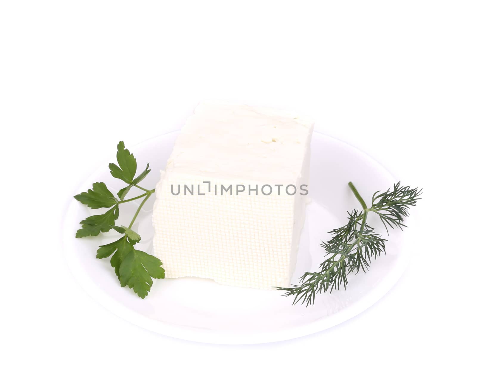 Sheep cheese on a white plate. Isolated on a white background.