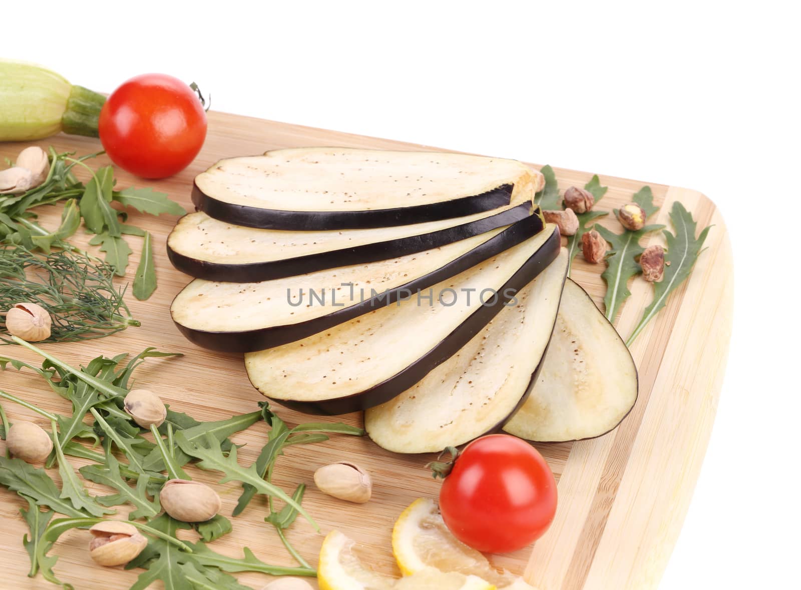Vegetables on wooden board. Isolated on a white background.