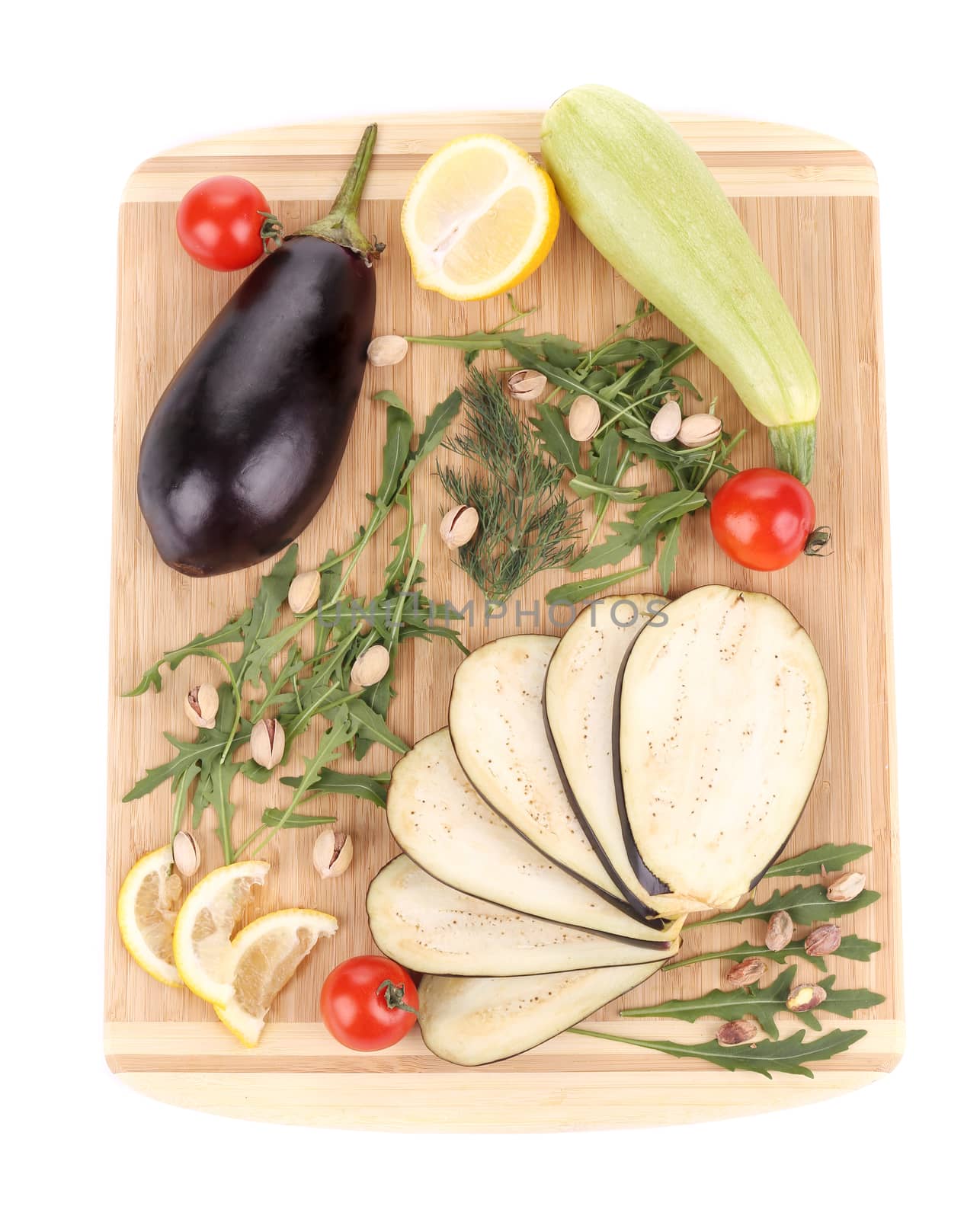Vegetables on wooden board. Isolated on a white background.