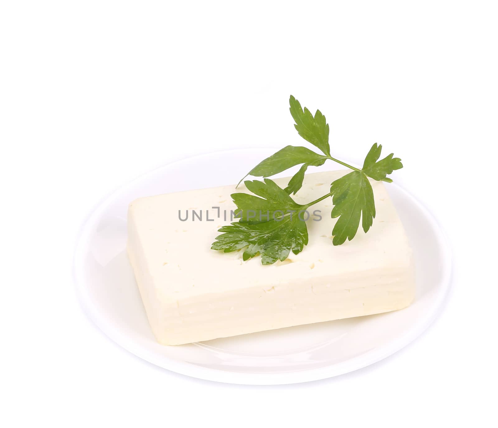 Tofu with parsley on a plate. Isolated on a white background.