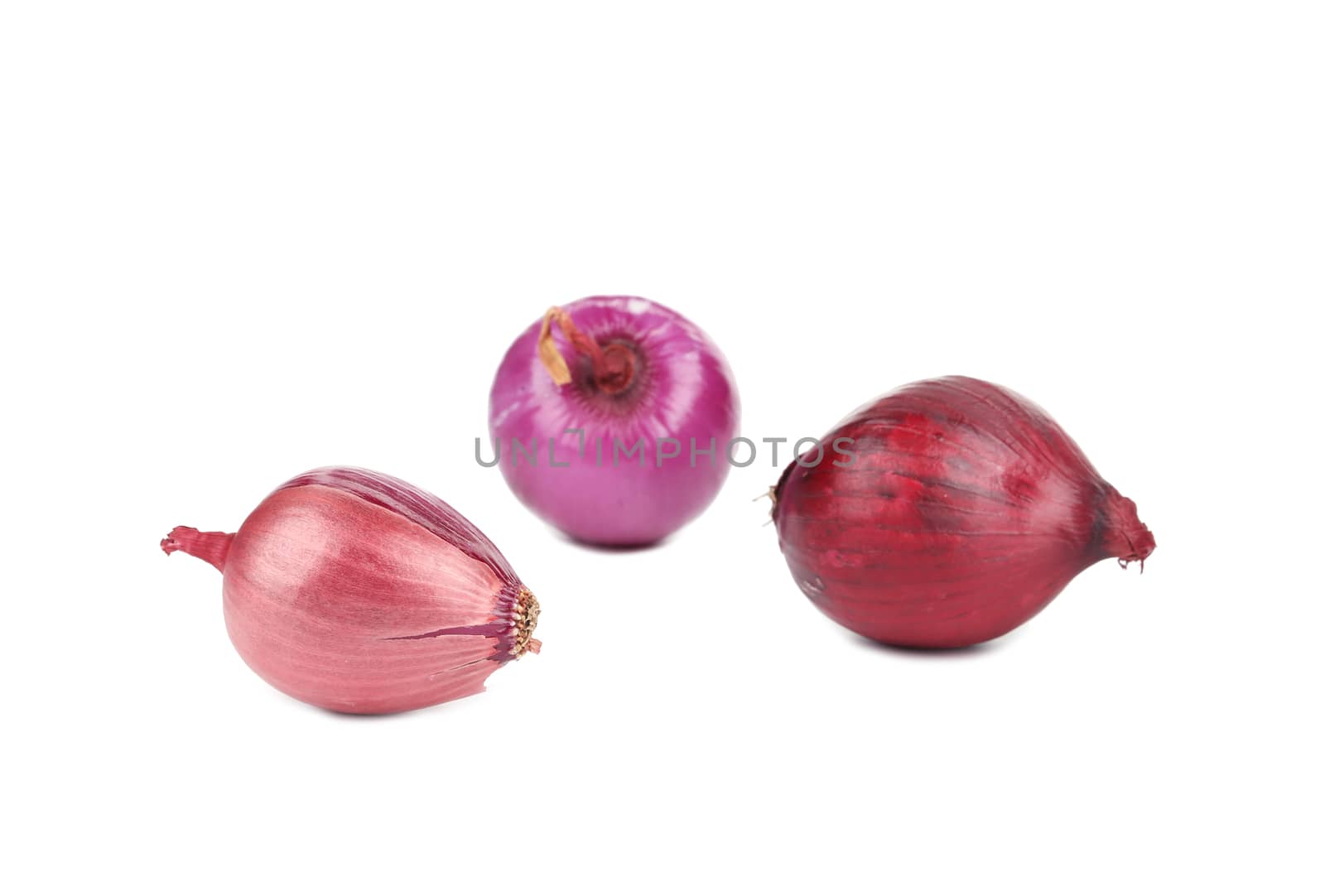 Three red onions. Isolated on a white background.