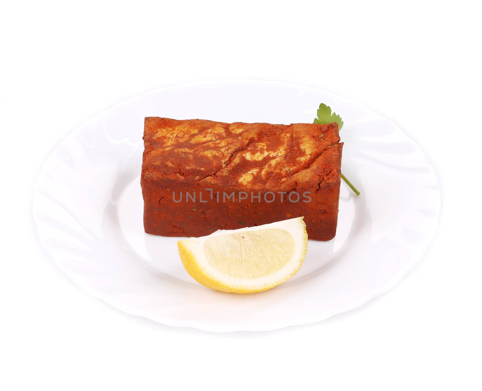 Tofu in paprika and lemon. Isolated on a white background.