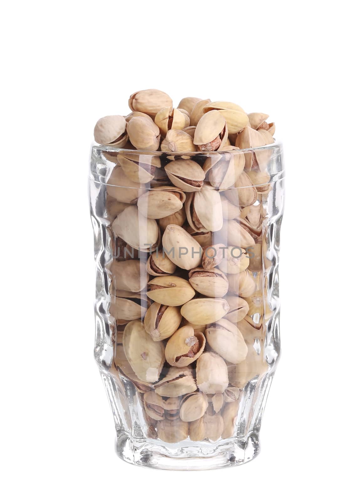 Beer mug full of pistachios. Isolated on a white background.