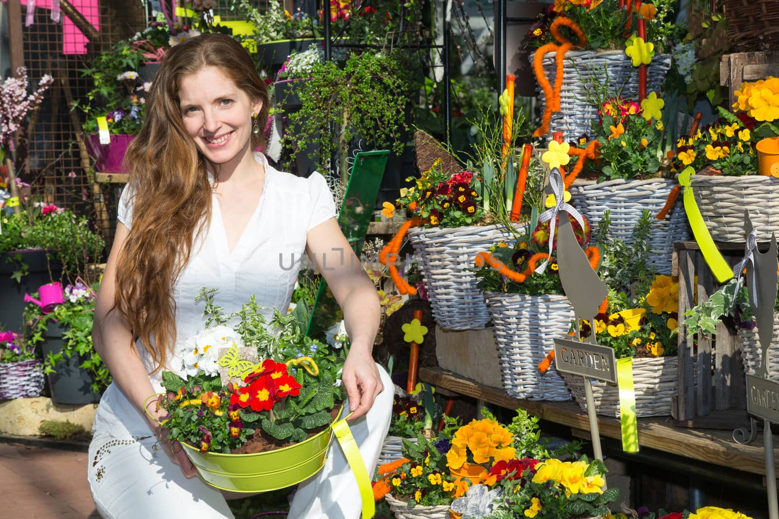 Customer in flower shop posing with floral arrangement by ikonoklast_fotografie