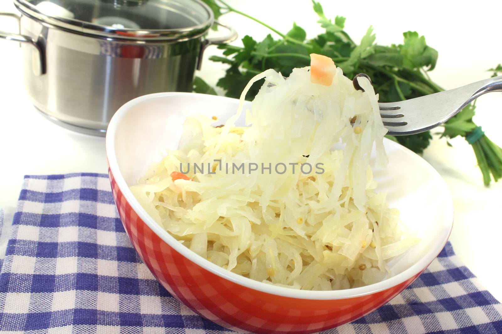 fresh Sauerkraut on a fork before light background