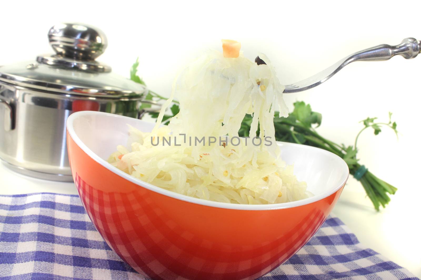 fresh delicious Sauerkraut on a fork before light background