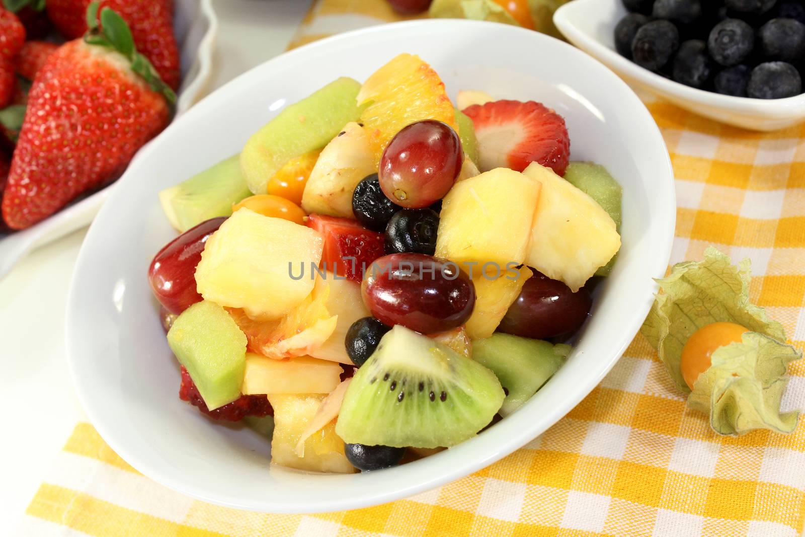 A white bowl with fresh fruit