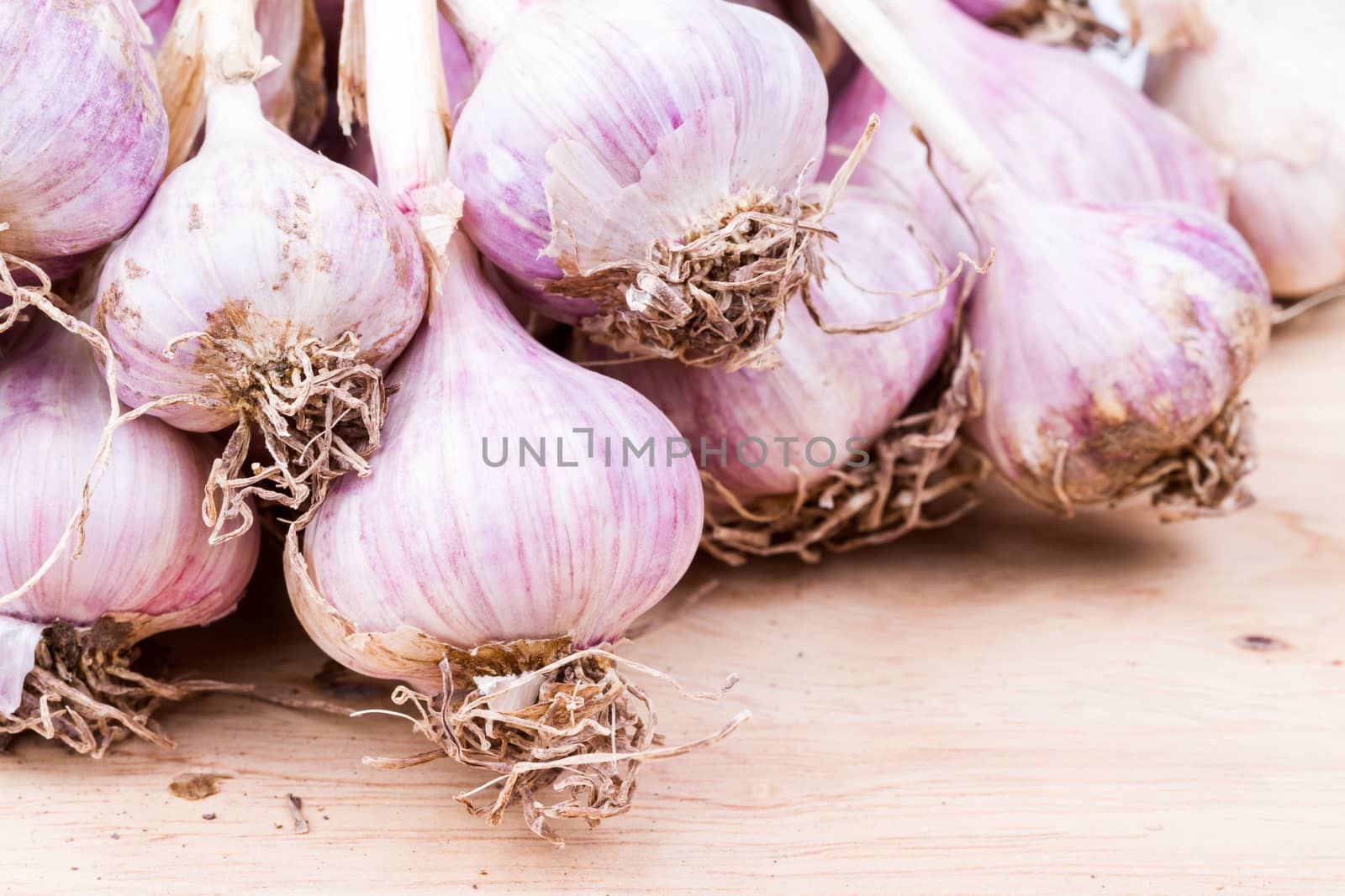 piles of garlic vegetable on wooden background