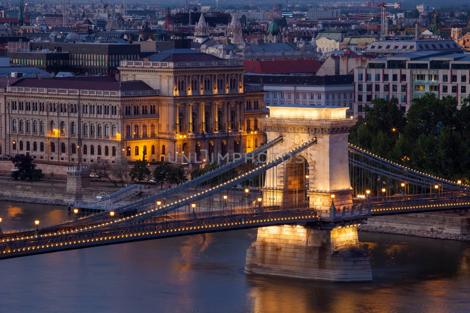 Budapest sunset cityscape with Chain Bridge in front over Danube river and Parliament Building in the background.