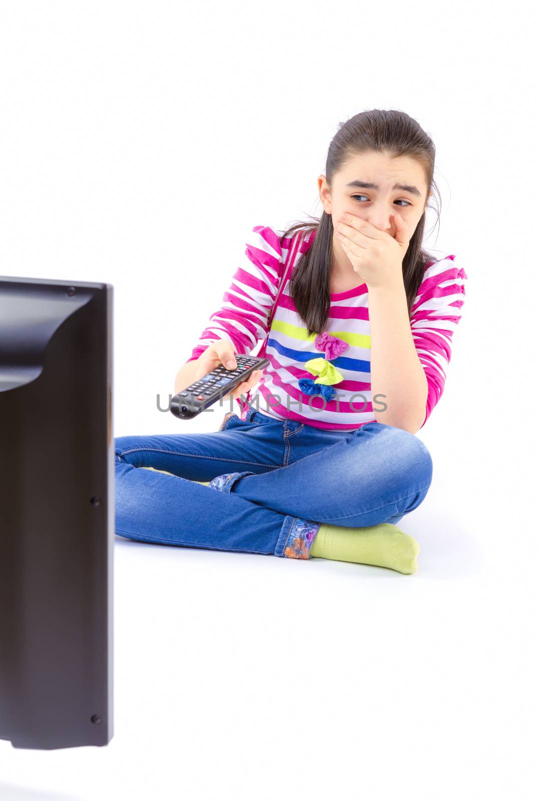 Scared  little girl watching tv by manaemedia