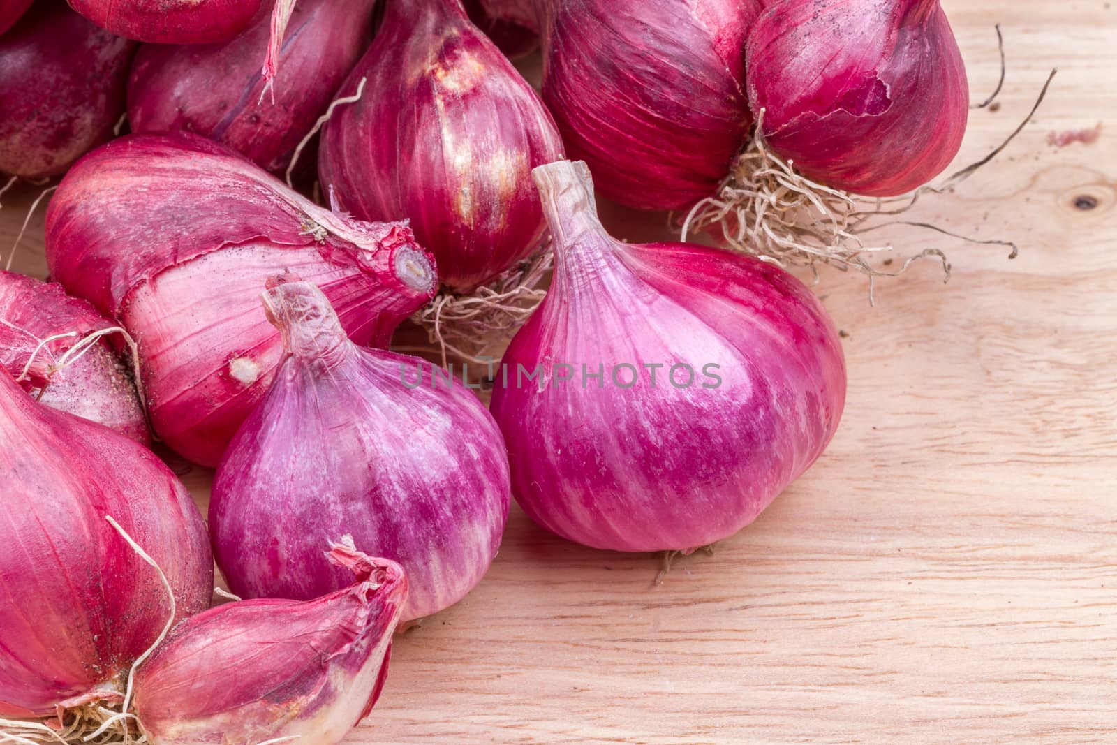 piles of shallots vegetable on wooden background