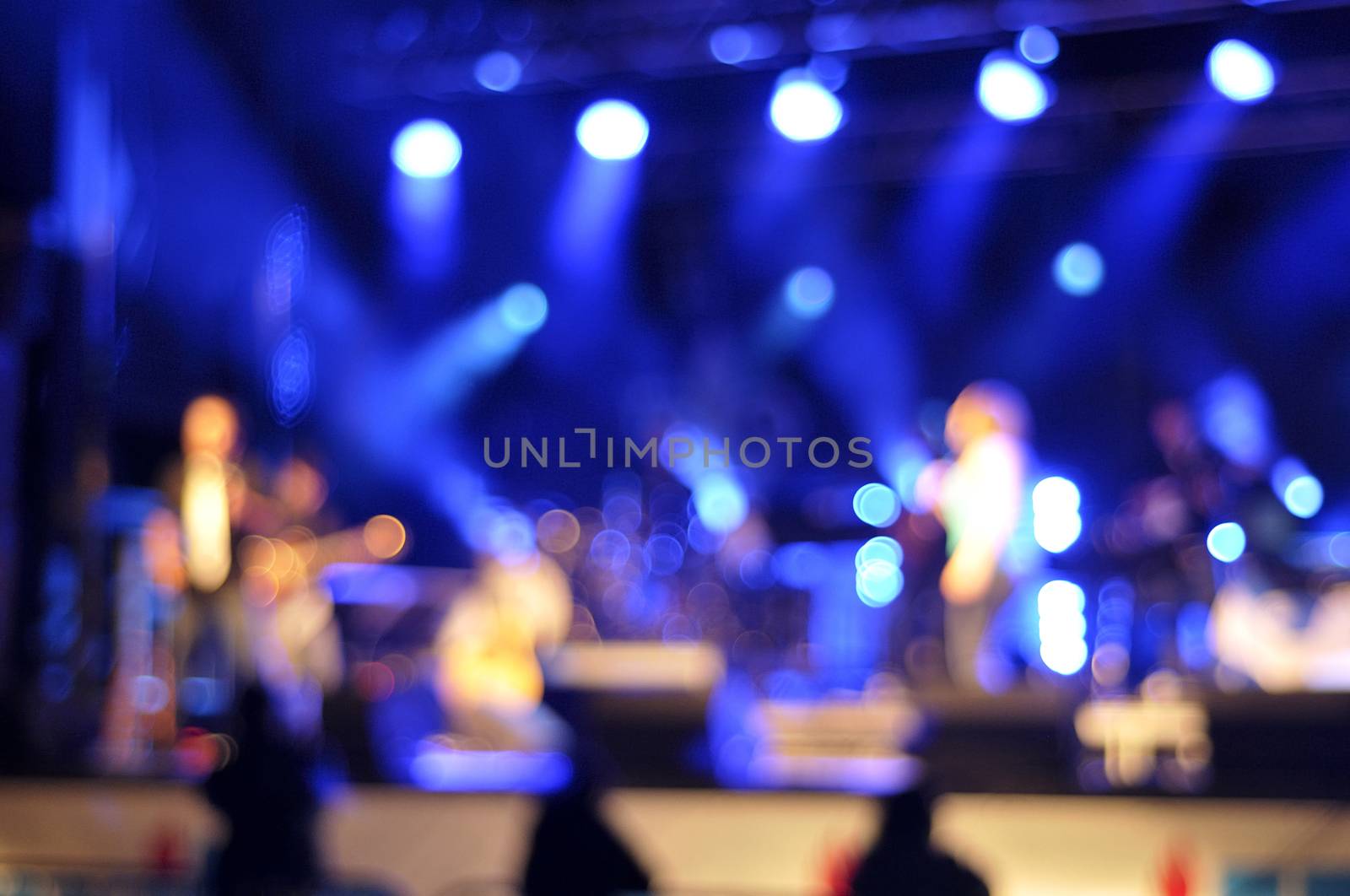 Silhouettes and bokeh against stage lighting by Hbak