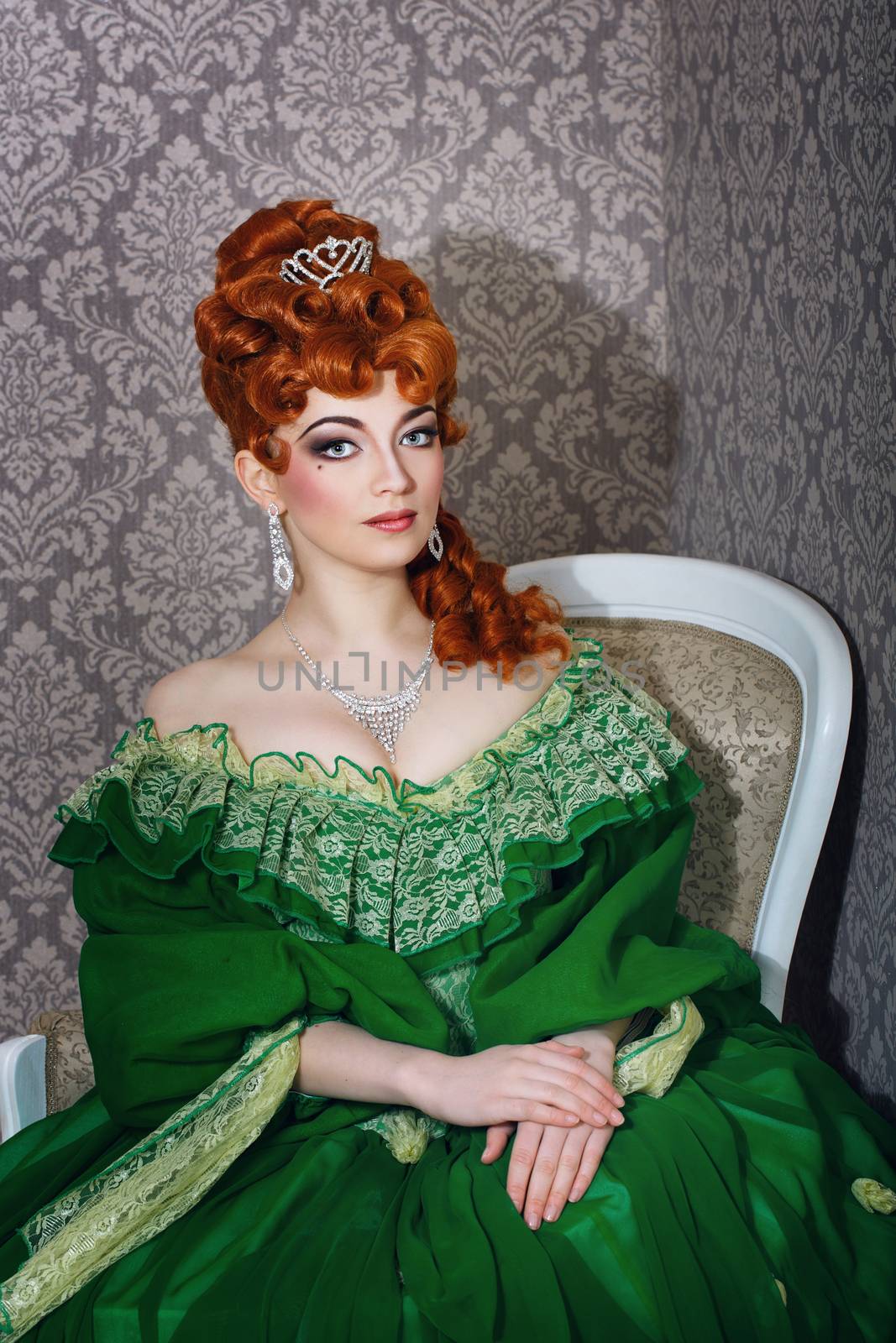 Attractive young girl in green gown and red wig