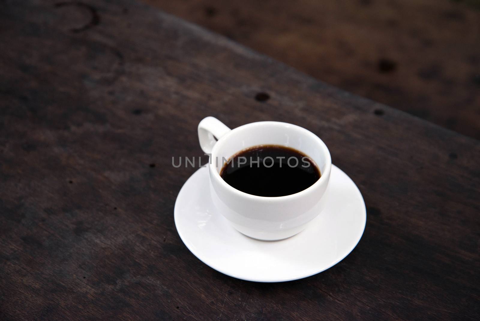 White Coffee Cup on a Wooden Table  by jakgree