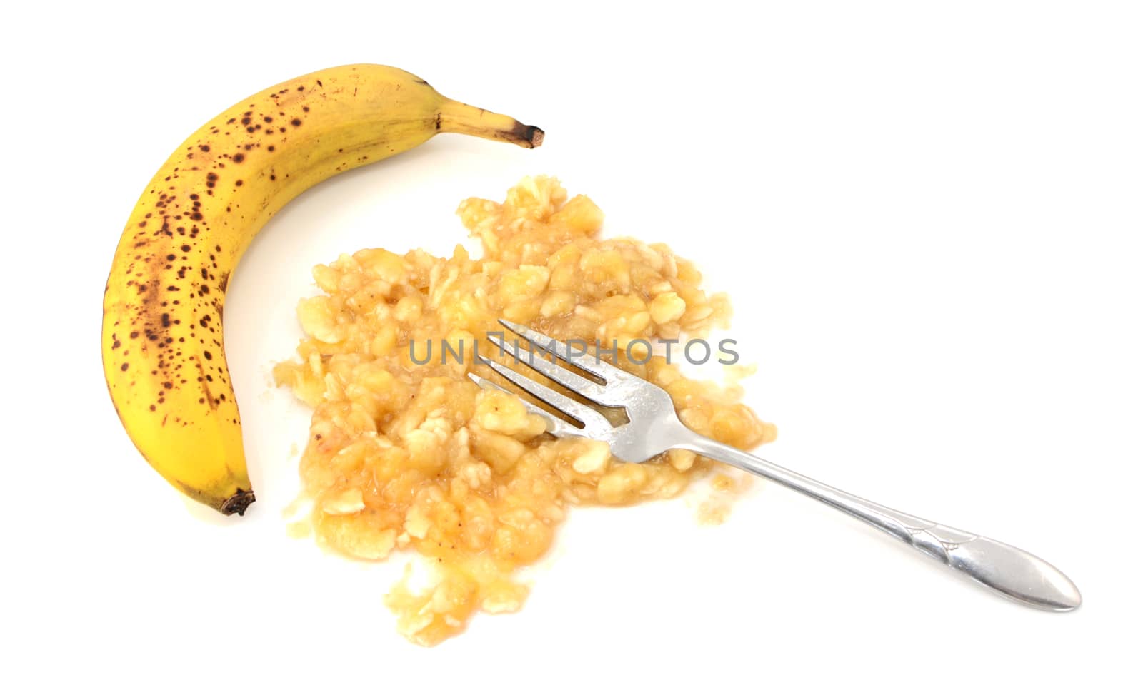 Overripe unpeeled banana with fork and pureed fruit, isolated on a white background