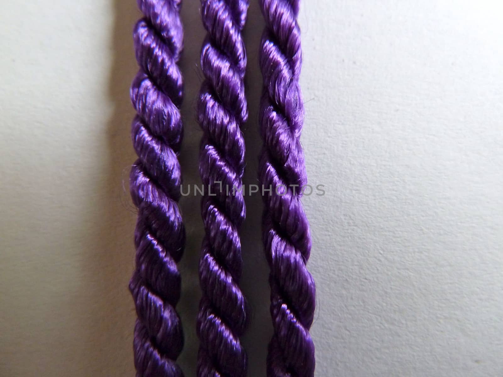 Three bright purple ropes in a line as a background