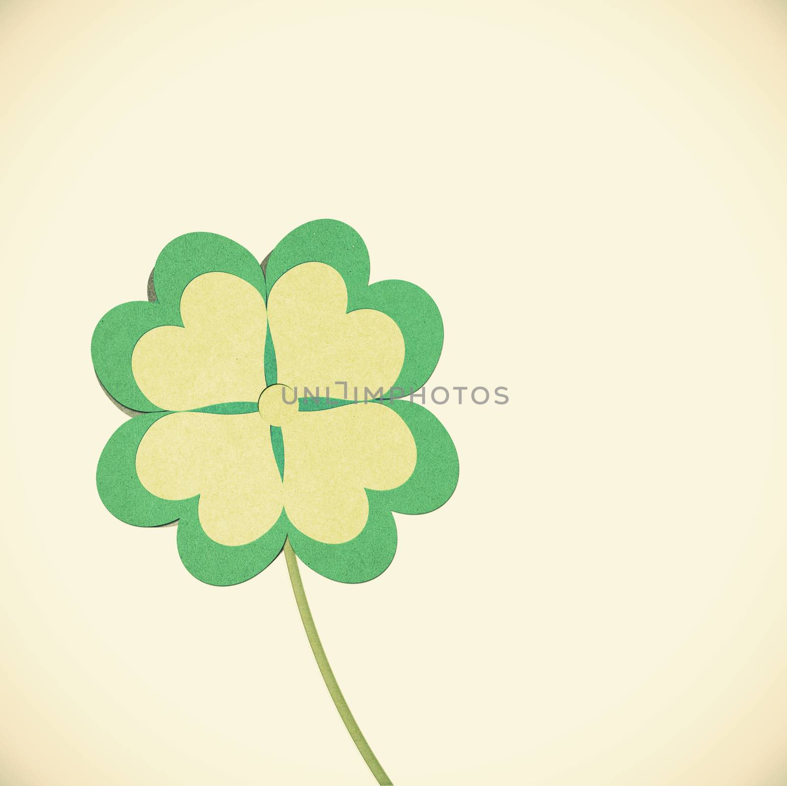 Old Paper texture clover with four leaves on vintage tone  background