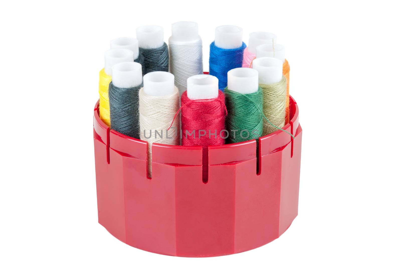 Colored spools of threads in a box isolated on white background