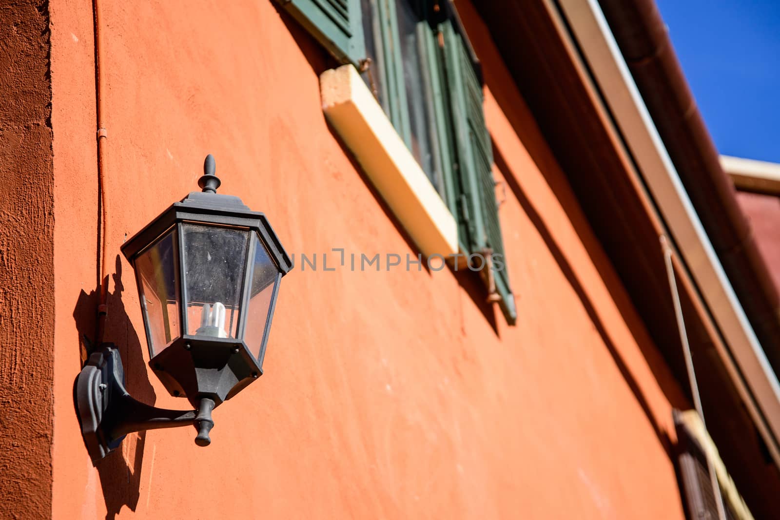 old-fashion lamp hanging on brick wall by jakgree
