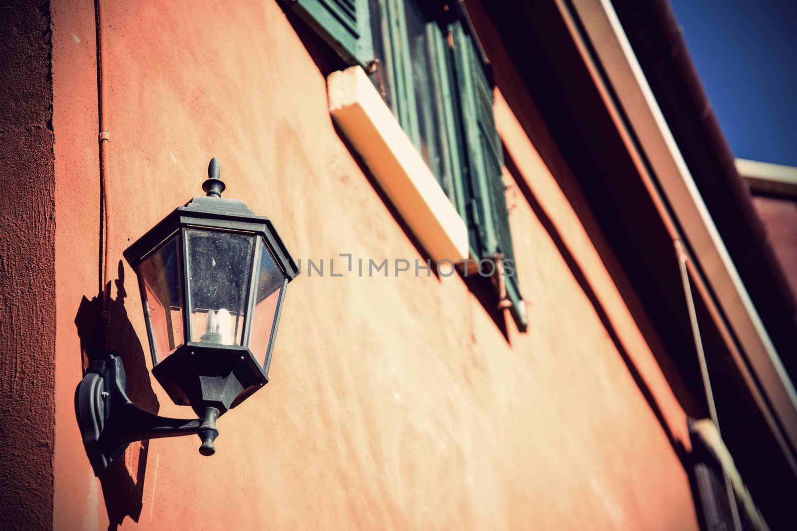 Vintage old-fashion lamp hanging on brick wall by jakgree