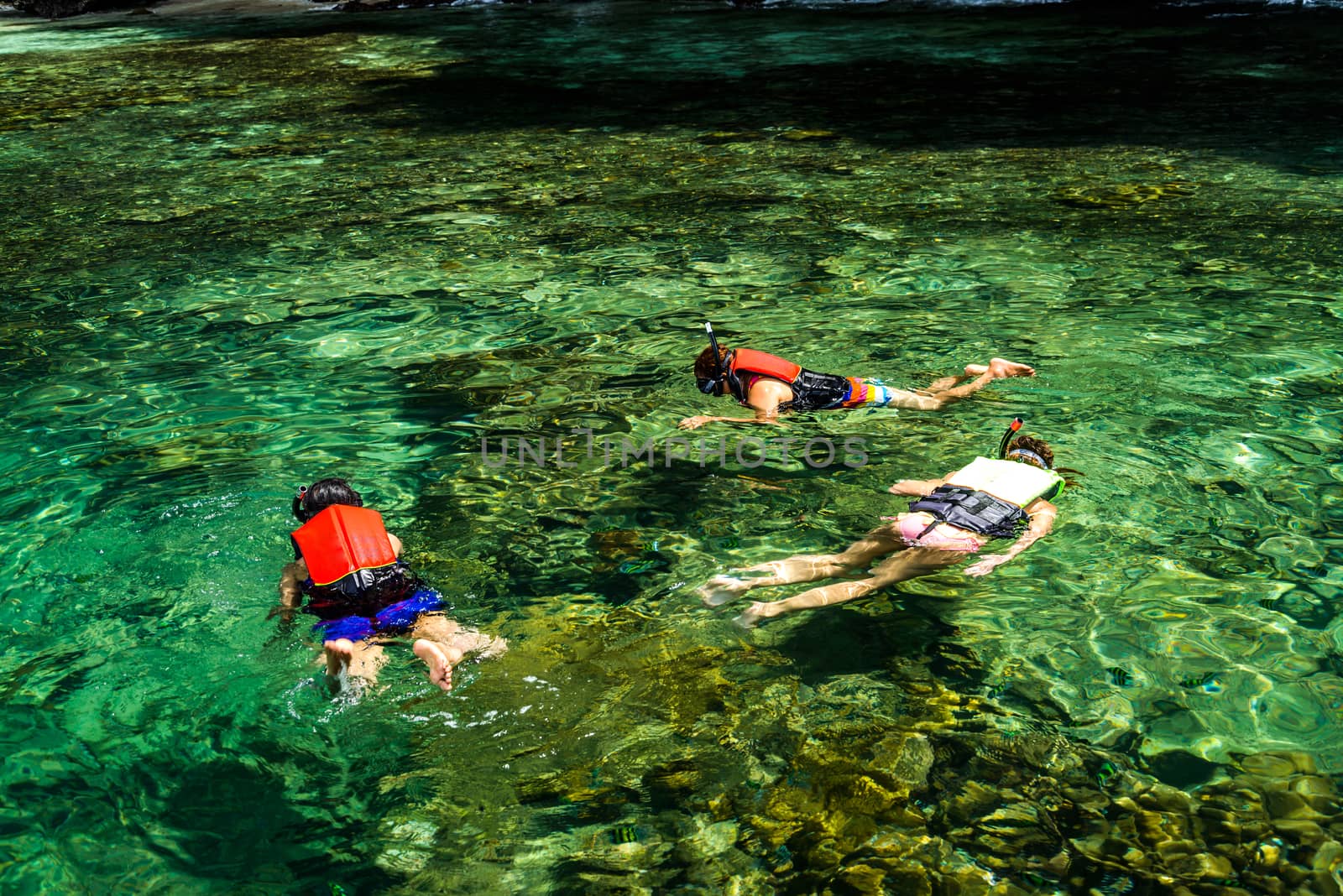 Family snorkeling on the Gulf of Thai , Thailand.