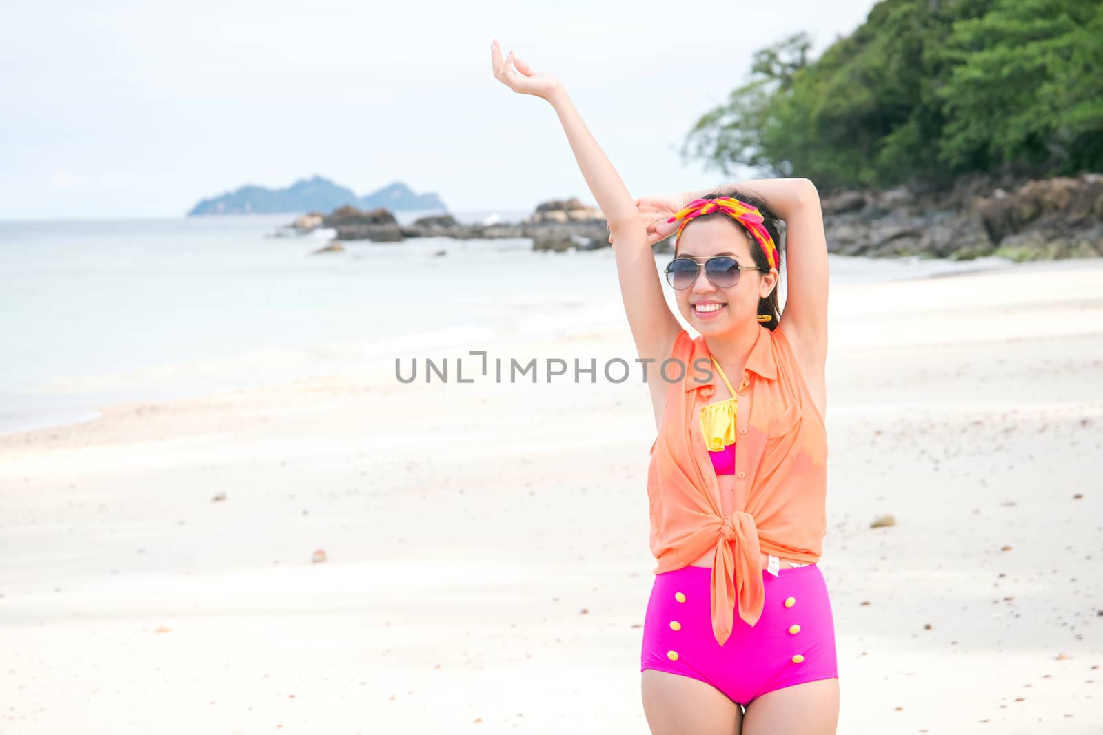 pretty woman enjoying summer sun by the sea by jakgree