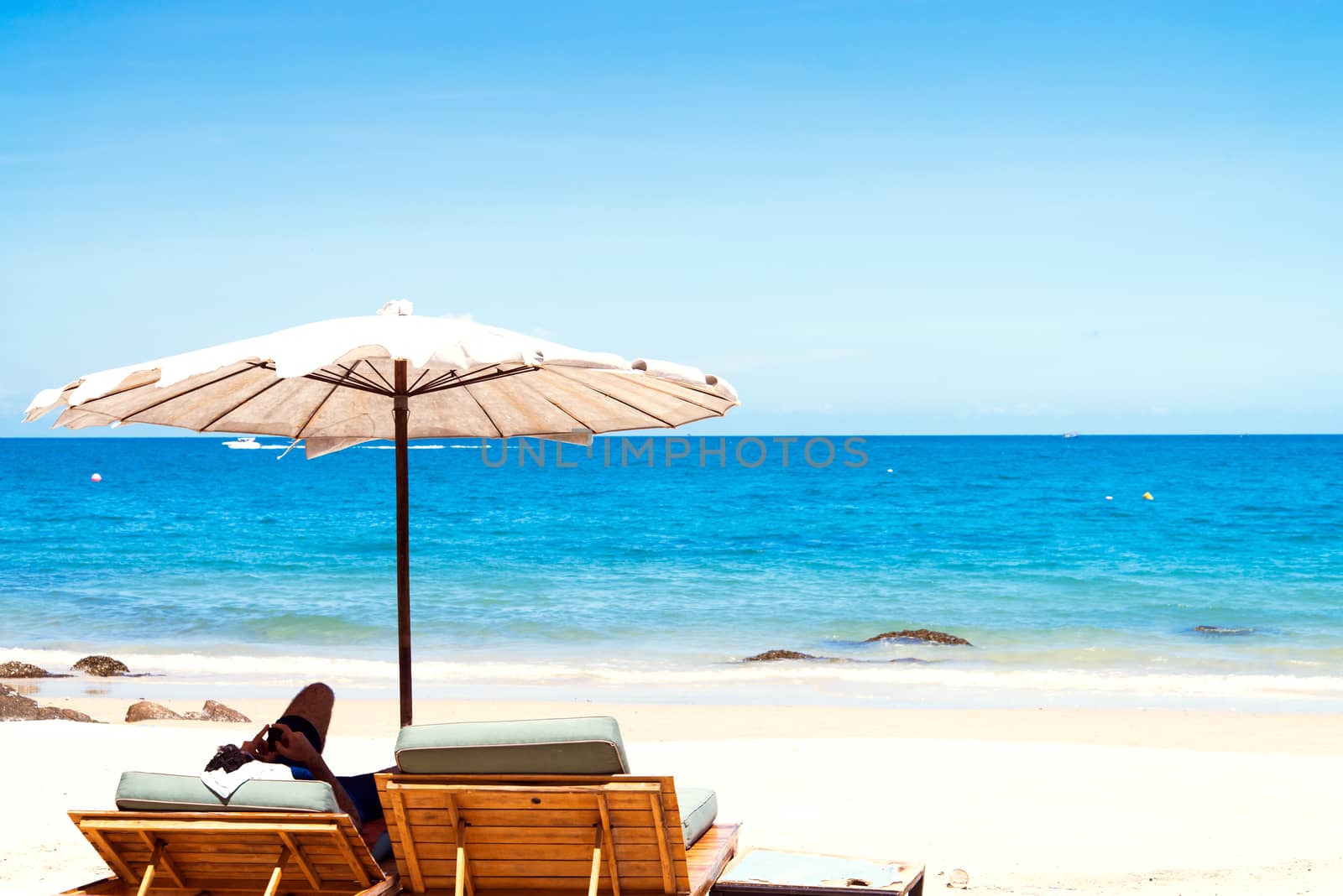 Beach chair and umbrella on sand beach. 