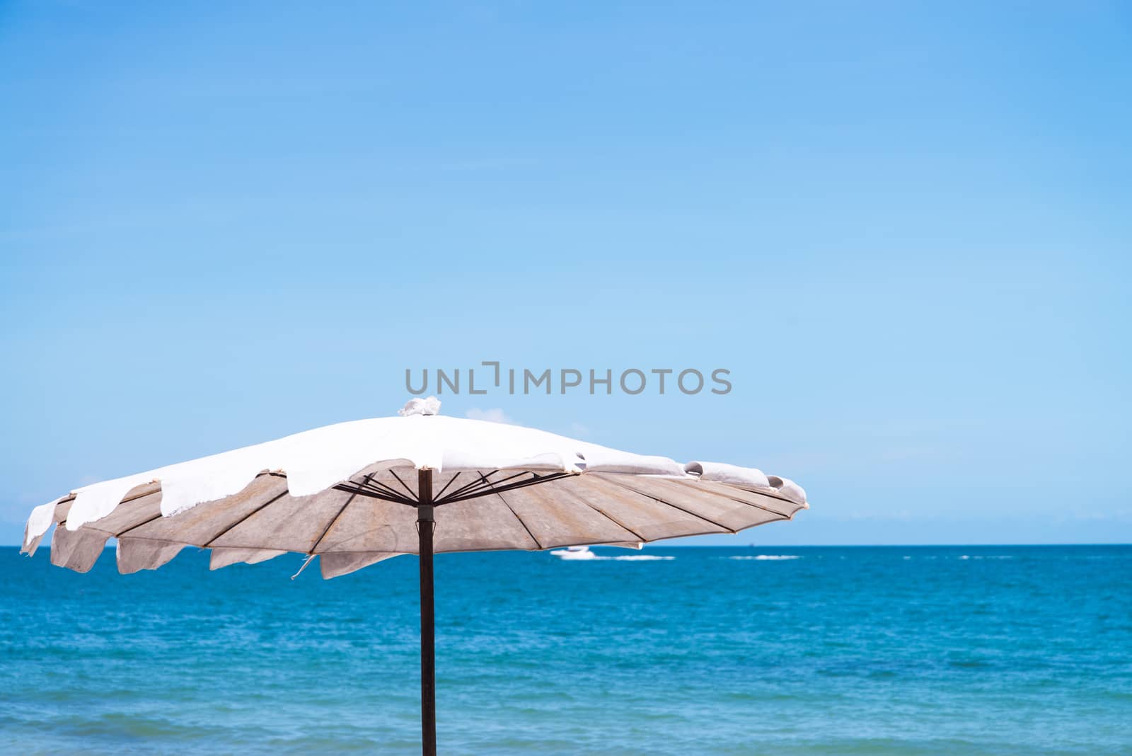 umbrella on sand beach.  by jakgree