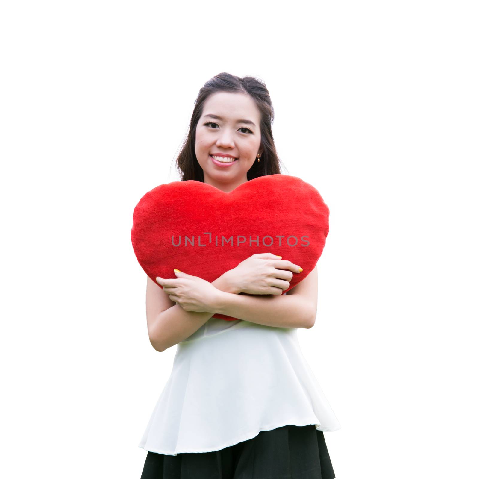 Women holding big love heart shape pillow isolated on white background,