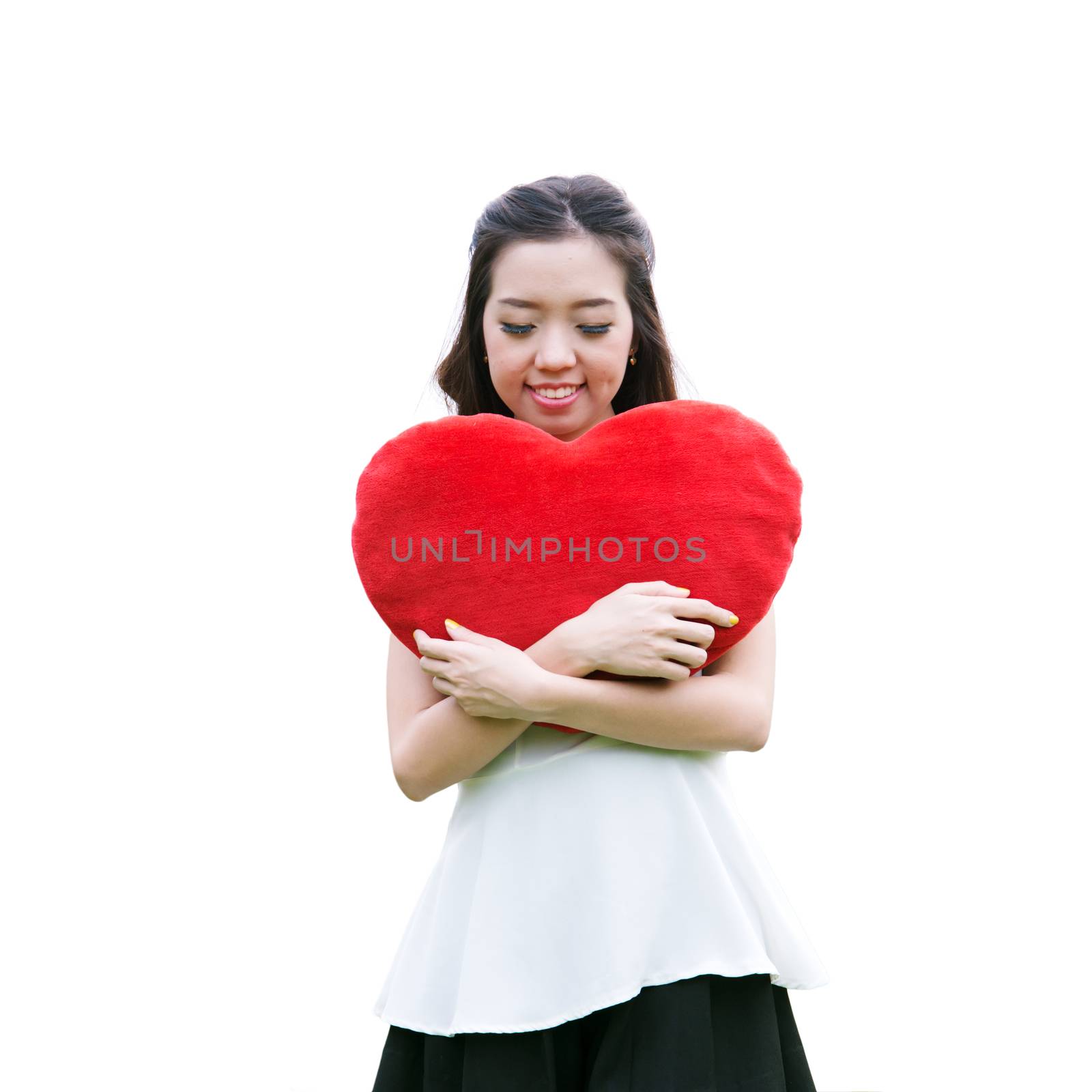 Women holding big love heart shape pillow isolated on white back by jakgree