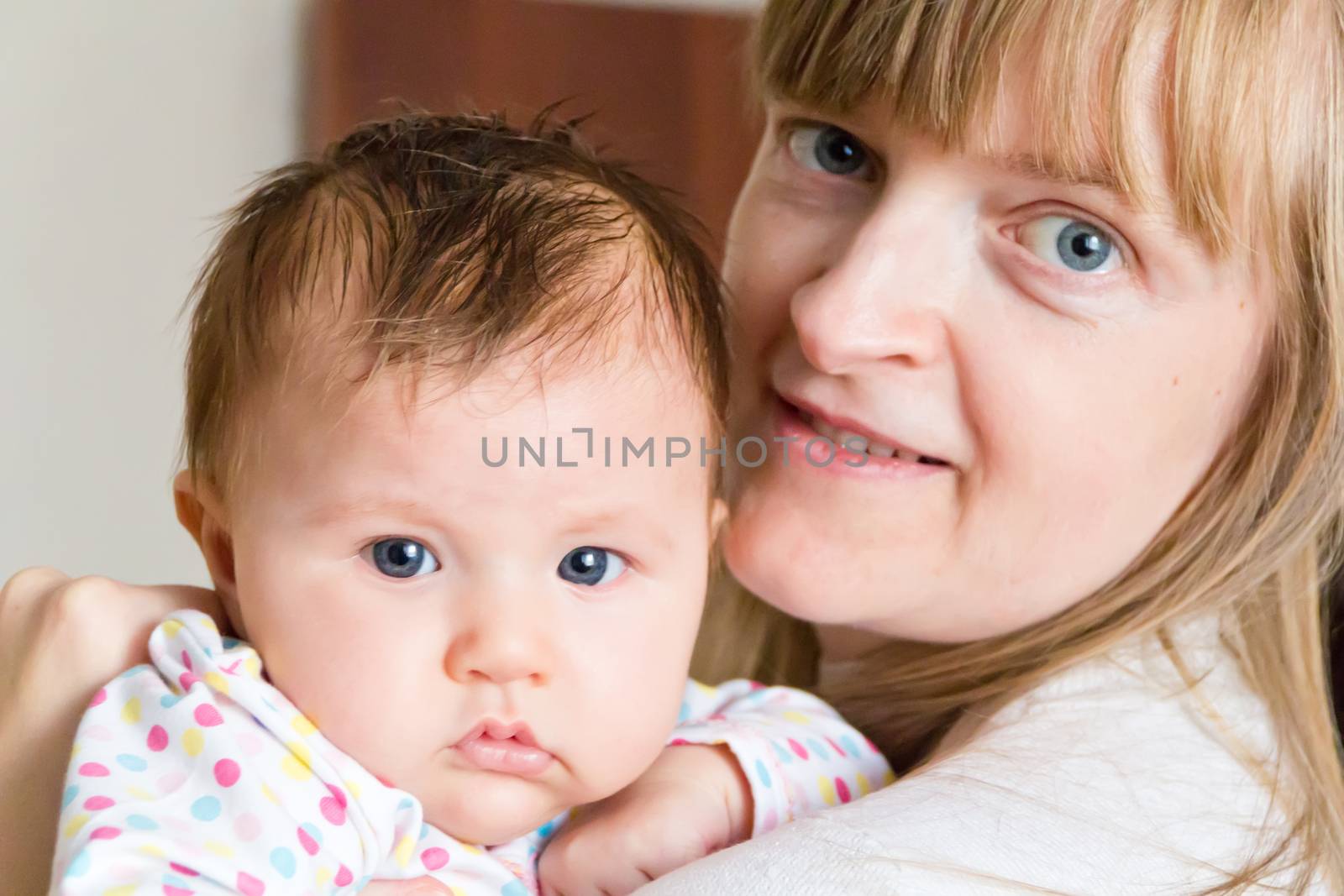 Photo of cute newborn infant girl and mother